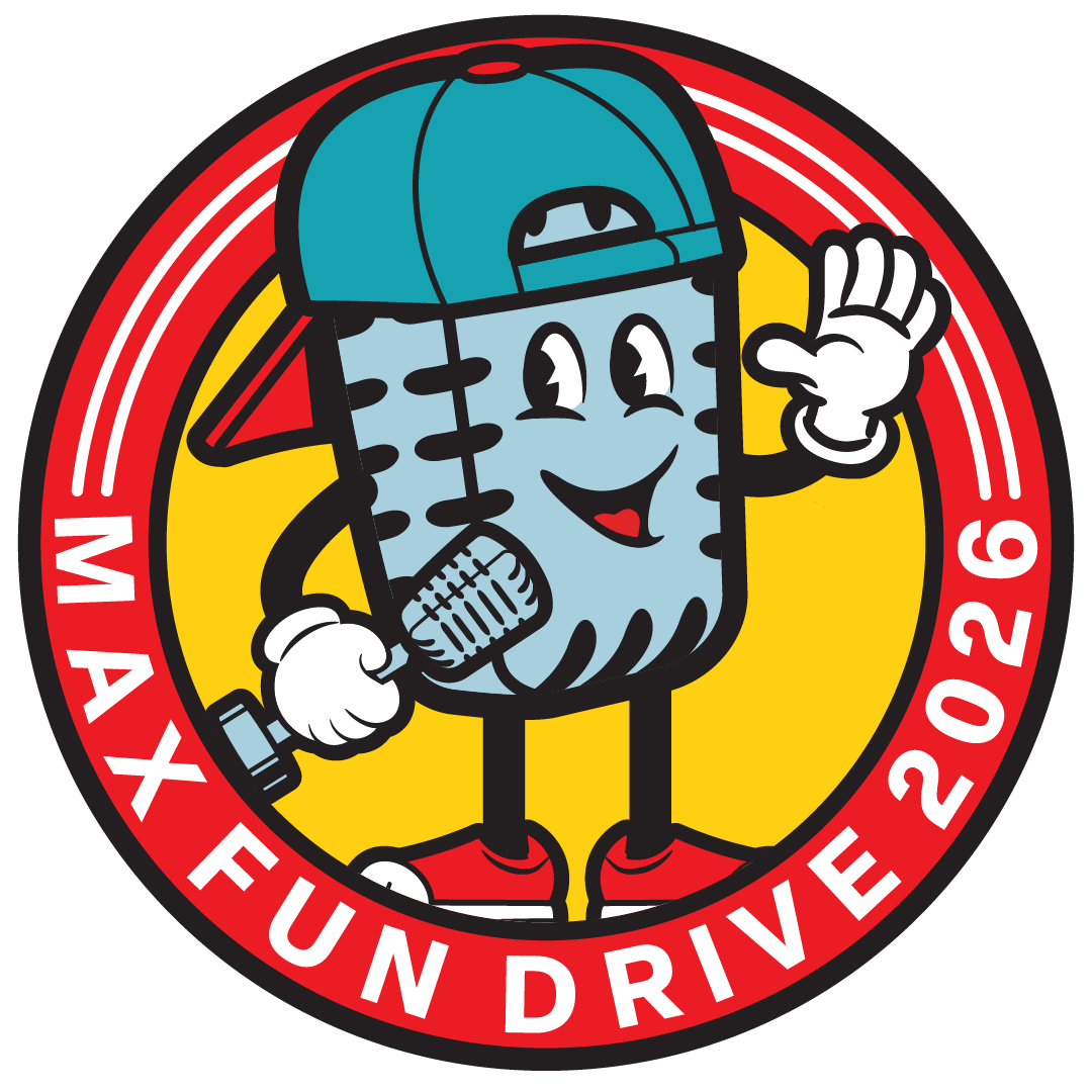 A smiling old timey microphone that is holding a microphone that looks just like him. He's wearing a backwards hat and standing inside a circle that says MaxFunDrive 2026.