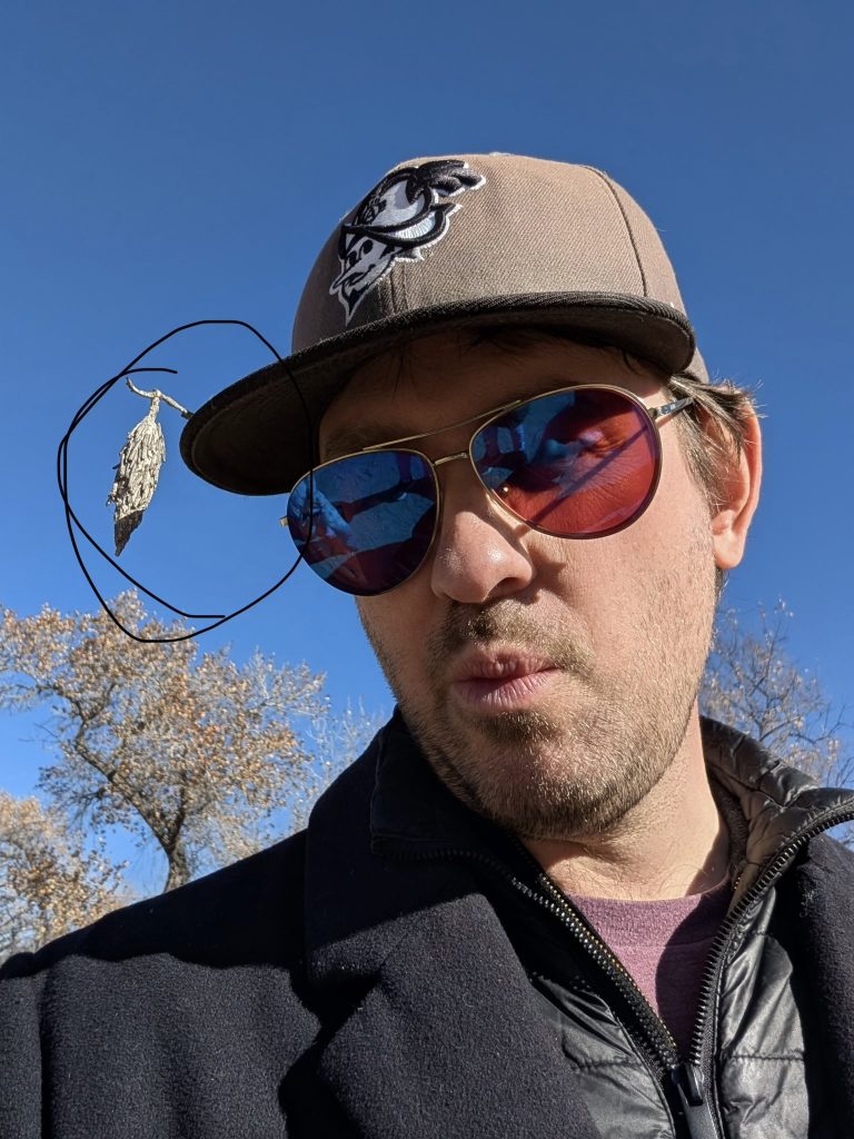 A man with a cocoon mounted on his baseball cap