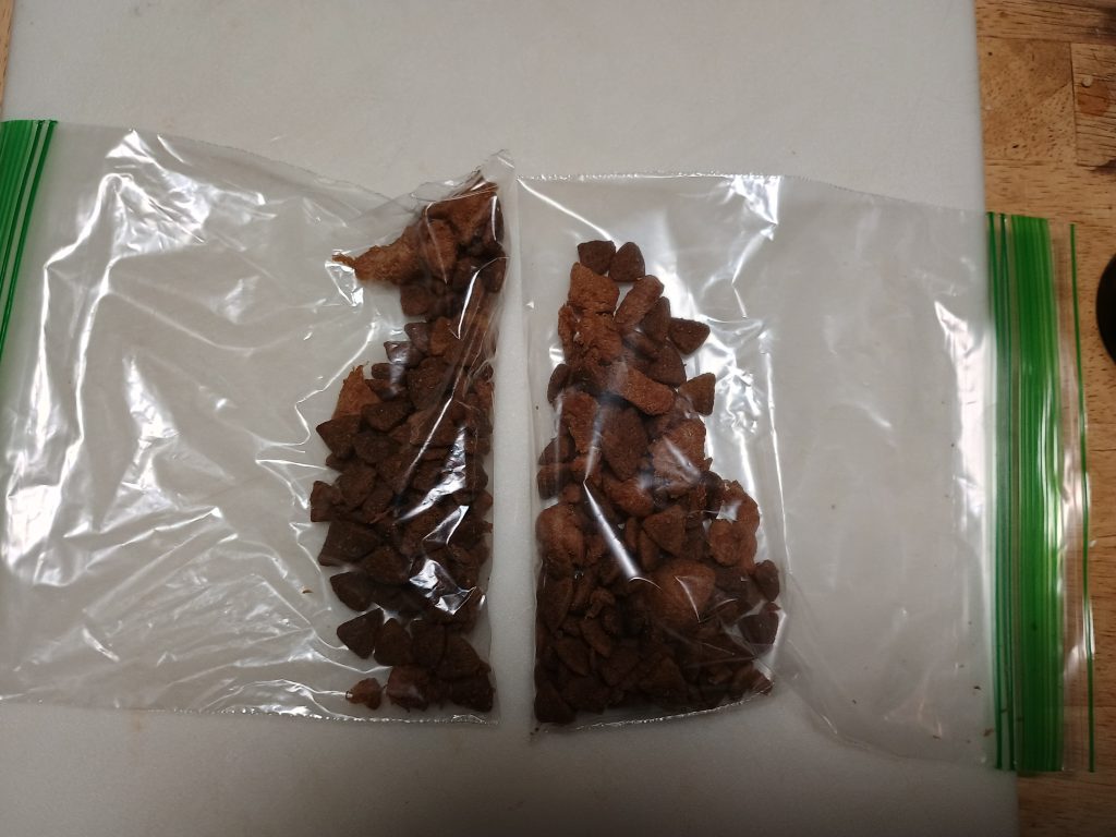 Two ziploc bags of dog kibble on a table