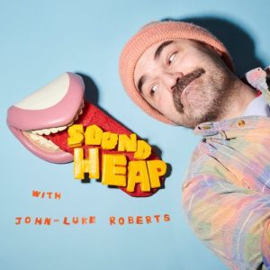 The logo for Sound Heap, featuring John Luke-Roberts looking over his shoulder at a model set of teeth with the tongue sticking out; the words "Sound Heap" sit on top of the tongue.